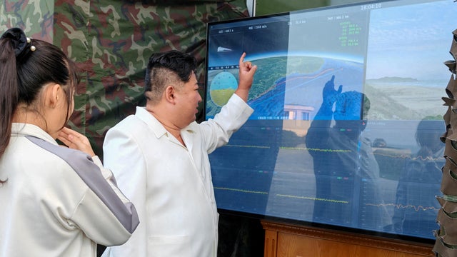 North Korean leader Kim Jong Un, accompanied by his daughter Kim Ju Ae, attends a test of a new type of weapon at an undisclosed location 