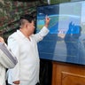 North Korean leader Kim Jong Un, accompanied by his daughter Kim Ju Ae, attends a test of a new type of weapon at an undisclosed location 