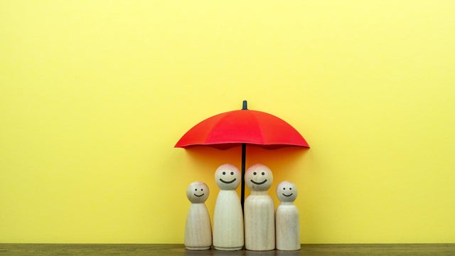 Wood Figurine with Smiling Face Under Red Umbrella 
