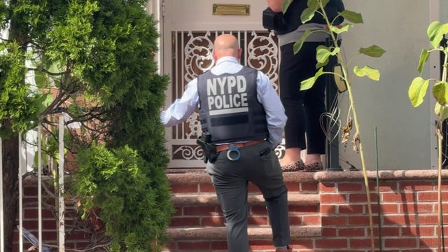 NYPD officer on front stoop 