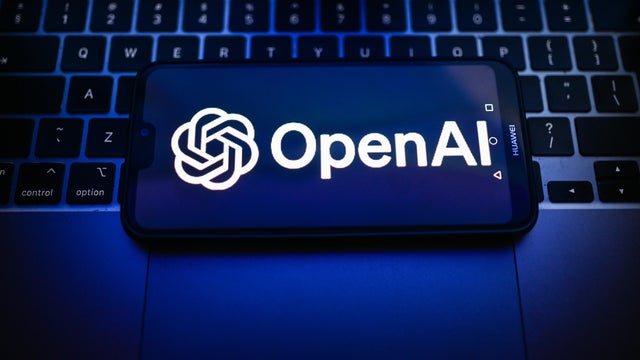 In this photo illustration, an OpenAI logo is seen displayed 