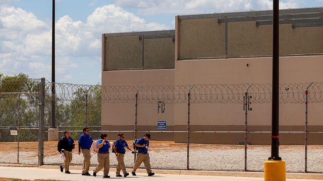 People walk toward the entrance of the South Texas ICE Processing Center in Pearsall, Texas, on Sept. 21, 2026. 