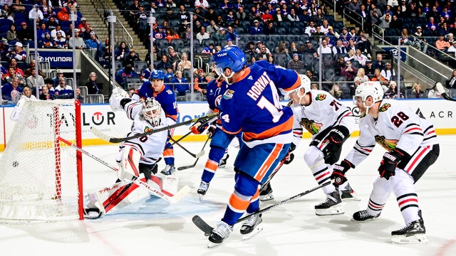 Bo Horvat #14 of the New York Islanders scores a power play goal past Arvid Soderblom #40 of the Chicago Blackhawks during the first period at UBS Arena on October 08, 2026 in Elmont, New York. 
