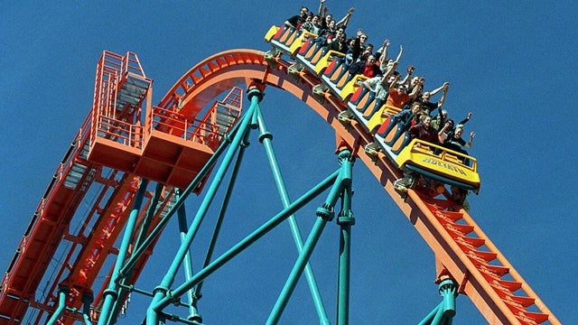 Roller coaster riders throw their hands in the air as they ride "Goliath," the newest roller coaster 