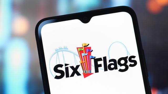In this photo illustration, the Six Flags Entertainment logo 