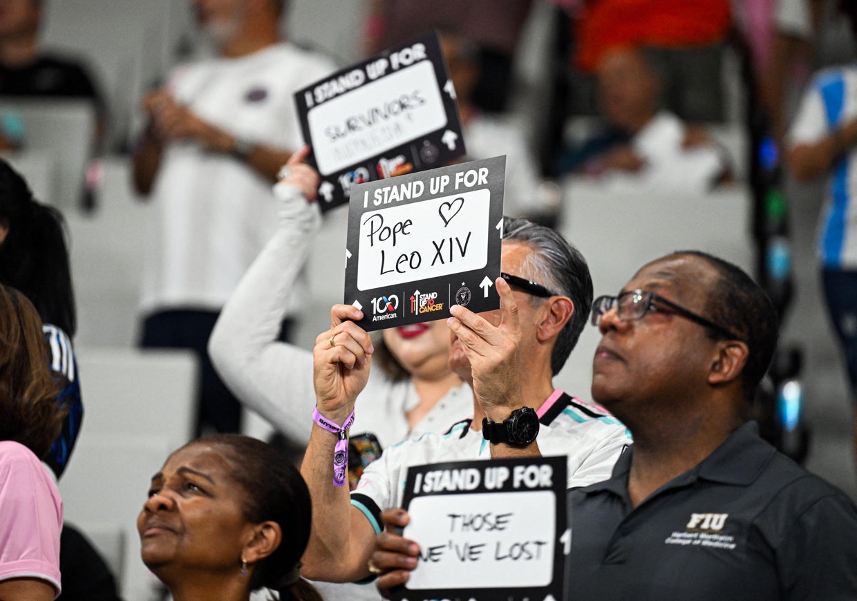 An attendee holds a sign for Pope Leo XIV at a football match between Inter Miami CF and New York City FC in Miami, Florida, on Oct. 14, 2026. CHANDAN KHANNA /AFP via Getty Images