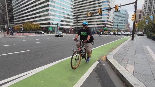 A cycling advocate rides a bike near City Hall in Philadelphia 
