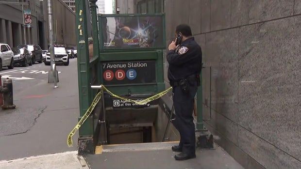 Seventh Avenue subway station with crime scene tape and police officer