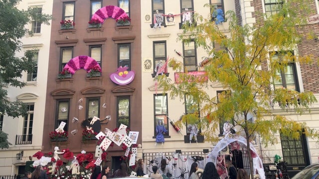 Apartment buildings decorated for Halloween with "Alice in Wonderland" and haunted asylum decorations 