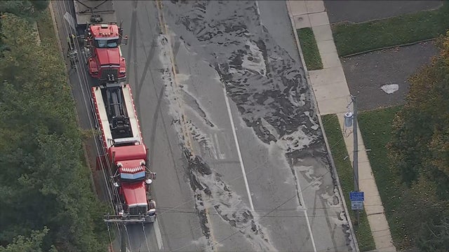 Chopper image of a truck next to a large spill on the road in Glenside 