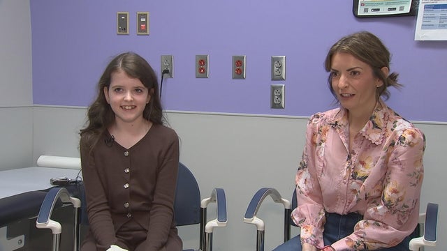 Maisie and her mom in a doctor's office at Shriners Philadelphia 