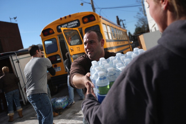 Volunteers unload water at an aid distribution center at the Long Beach Ice Arena on November 4, 2012 in Long Beach.  (Photo by John Moore/Getty Images)