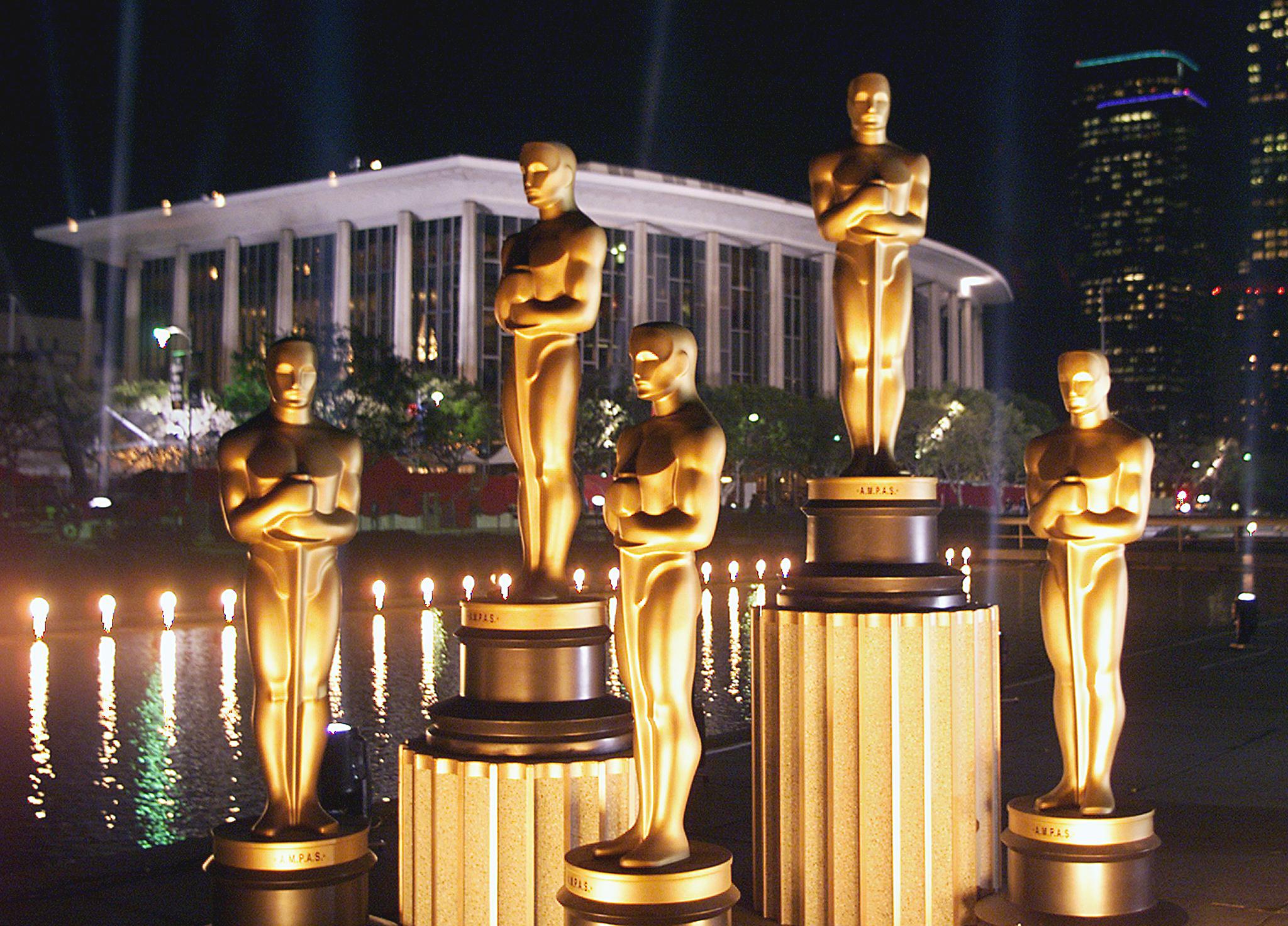 Replicas of Oscar statues are lit in the night out