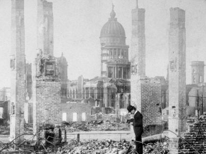 A man photographs the ruins of a building block in front of the remains of City Hall near Market and Seventh Streets after the Great Earthquake in San Francisco, California. The city hall which took 27 years to build at an estimated cost of $6 million, crumbled in less than 30 seconds during the quake. (Hulton Archive/Getty Images)