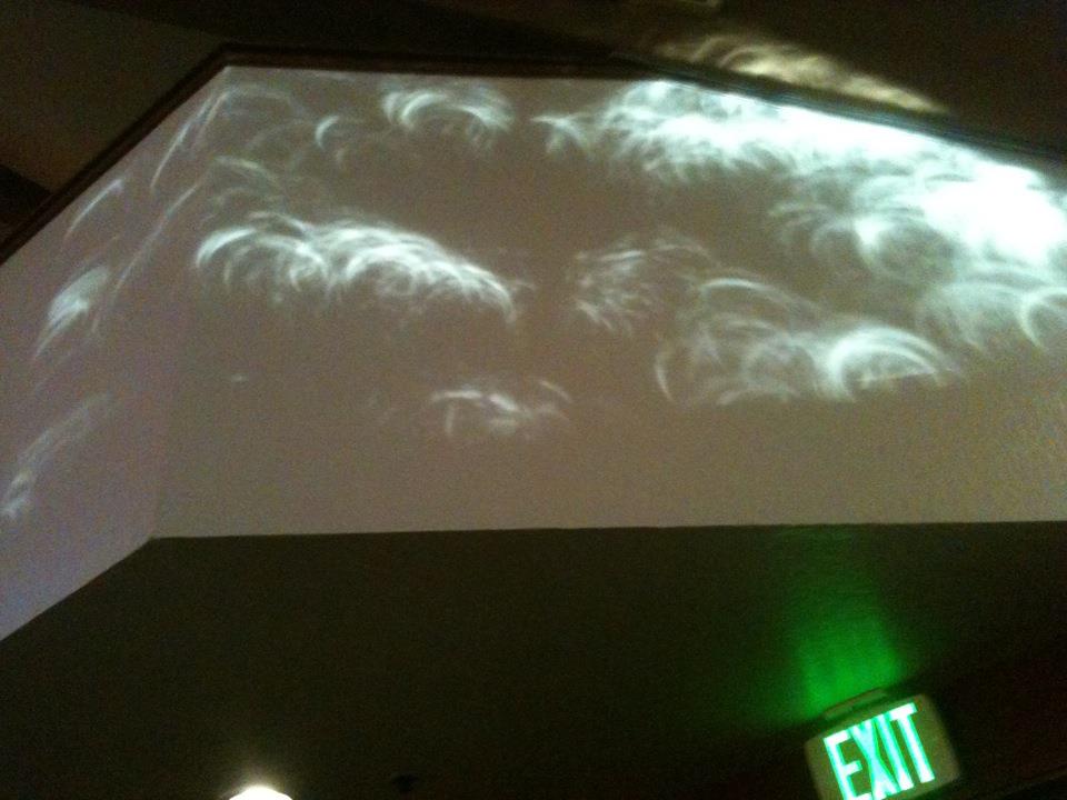 May 20th, 2012 Solar Eclipse seen in the shadows projected by the holes between tree leaves, seen in the shadow on a wall in Sacramento, California.