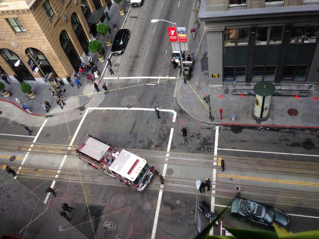 Emergency crews at the intersection of California and Montgomery Streets in San Francisco where window washer fell 11 stories and landed on top of a car (shown here).