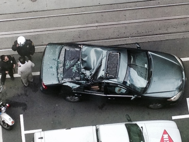 A window washer fell 11 stories from a building near California and Montgomery Streets in San Francisco, and landed on top of the car shown here.