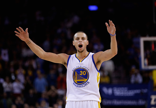 Stephen Curry #30 of the Golden State Warriors tries to get the crowd louder during the fourth quarter of their game against the Houston Rockets at ORACLE Arena on December 10, 2014 in Oakland. (Ezra Shaw/Getty Images)