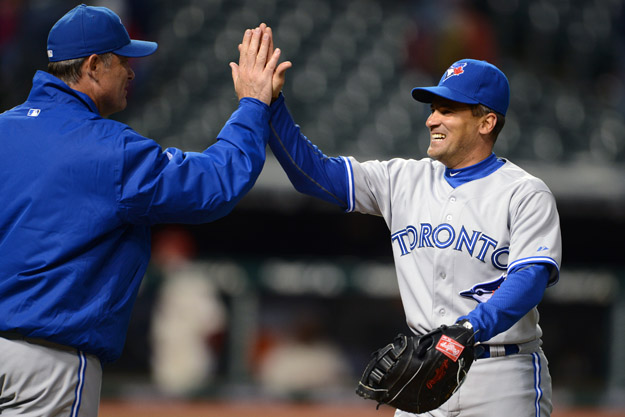 CLEVELAND, OH - APRIL 5: Manager John Farrell #52 and Omar Vizquel #17 of the Toronto Blue Jays celebrate after the Blue Jays defeated the Cleveland Indians 7-4 in 16 innings at Progressive Field on April 5, 2012 in Cleveland, Ohio. 