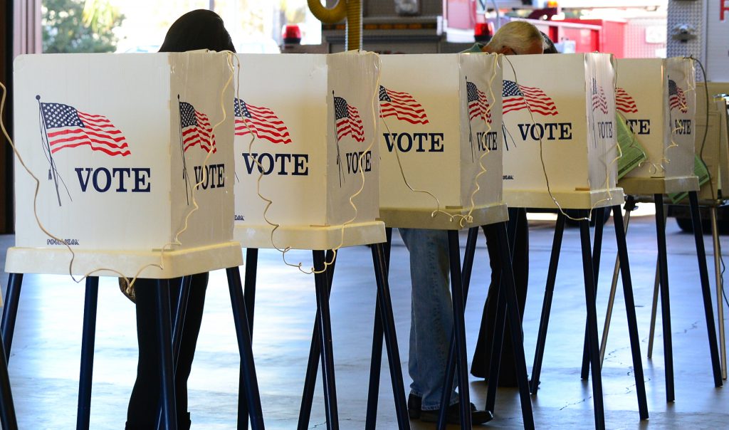 File photo of voting booths. (Photo by FREDERIC J. BROWN/AFP/Getty Images)