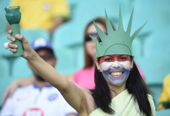 USA's fan cheers before a Round of 16 football match between Belgium and USA (credit: MARTIN BUREAU/AFP/Getty Images)