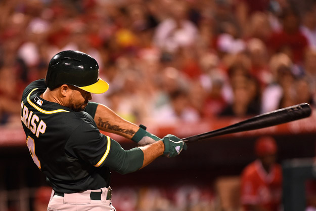ANAHEIM, CA - AUGUST 28:  Coco Crisp #4 of the Oakland Athletics hits an RBI single in the fifth inning against the Los Angeles Angels of Anaheim at Angel Stadium of Anaheim on August 28, 2014 in Anaheim, California.