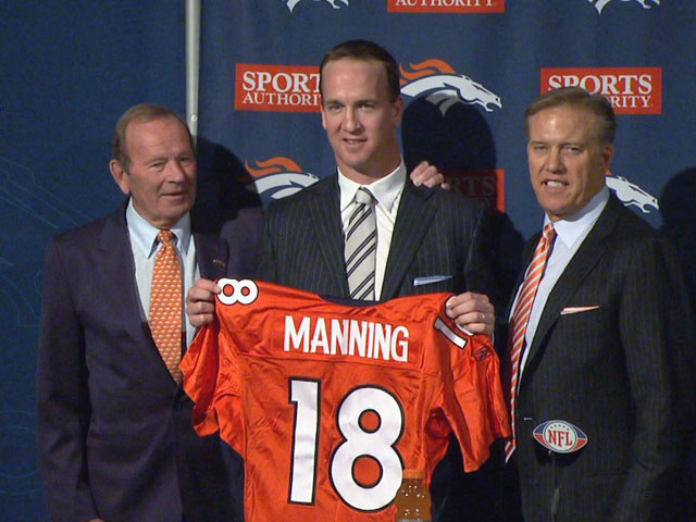 Peyton Manning, center, with Broncos owner Pat Bowlen, left, and VP of Football Operations John Elway, right on March 19, 2012. The Broncos signed Manning after he was waived by the Indianapolis Colts. (credit: CBS)