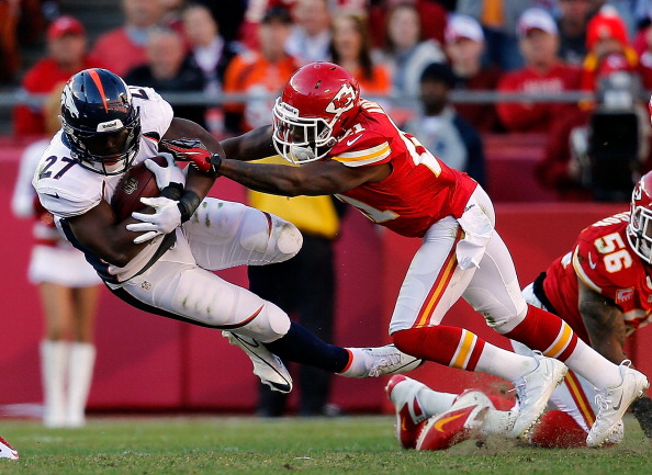 KANSAS CITY, MO - NOVEMBER 25: Running back Knowshon Moreno #27 of the Denver Broncos is pushed down by cornerback Javier Arenas #21 of the Kansas City Chiefs during the game at Arrowhead Stadium on November 25, 2012 in Kansas City, Missouri. (Photo by Jamie Squire/Getty Images)