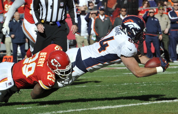 KANSAS CITY, MO - NOVEMBER 25: Tight end Jacob Tamme #84 of the Denver Broncos dives across the line for a touchdown against Eric Berry #29 of the Kansas City Chiefs during the first half on November 25, 2012 at Arrowhead Stadium in Kansas City, Missouri. (Photo by Peter Aiken/Getty Images)