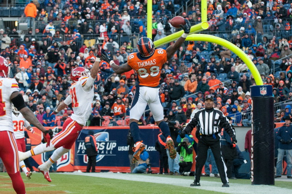DENVER, CO - DECEMBER 30: Wide receiver Demaryius Thomas #88 of the Denver Broncos hauls in an acrobatic touchdown reception under coverage by cornerback Javier Arenas #21 of the Kansas City Chiefs during a game at Sports Authority Field Field at Mile High on December 30, 2012 in Denver, Colorado. The Broncos defeated the Chiefs 38-3. (Photo by Dustin Bradford/Getty Images)