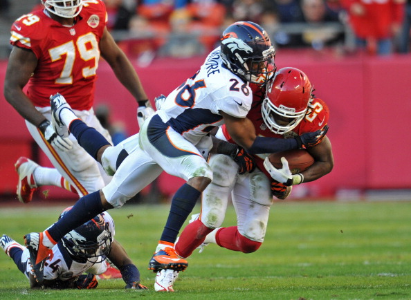 KANSAS CITY, MO - NOVEMBER 25: Free safety Rahim Moore #26 of the Denver Broncos tackles running back Jamaal Charles #25 of the Kansas City Chiefs during the second half on November 25, 2012 at Arrowhead Stadium in Kansas City, Missouri. Denver defeated Kansas City 17-9. (Photo by Peter Aiken/Getty Images)