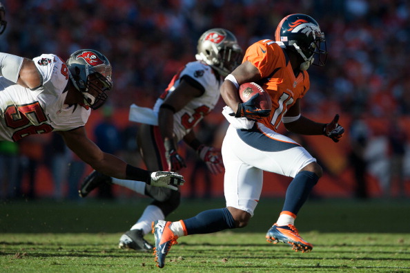 DENVER, CO - DECEMBER 2: Wide receiver Trindon Holliday #11 of the Denver Broncos returns a kickoff as linebacker Dekoda Watson #56 of the Tampa Bay Buccaneers misses a tackle at Sports Authority Field Field at Mile High on December 2, 2012 in Denver, Colorado. (Photo by Dustin Bradford/Getty Images)