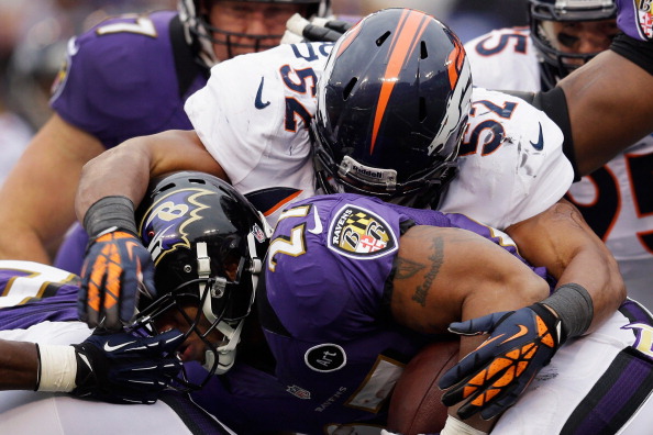 BALTIMORE, MD - DECEMBER 16: Outside linebacker Wesley Woodyard #52 of the Denver Broncos tackles running back Ray Rice #27 of the Baltimore Ravens during the first half at M&T Bank Stadium on December 16, 2012 in Baltimore, Maryland. (Photo by Rob Carr/Getty Images)