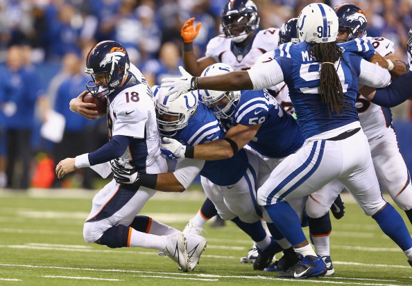 INDIANAPOLIS, IN - OCTOBER 20:  Peyton Manning #18 of the Denver Broncos is sacked during the game against the Indianapolis Colts at Lucas Oil Stadium on October 20, 2013 in Indianapolis, Indiana.  (Photo by Andy Lyons/Getty Images)