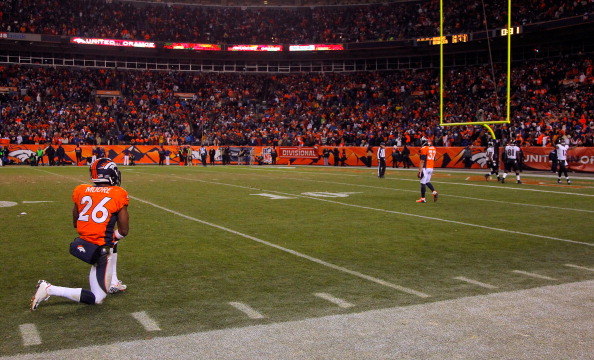 DENVER, CO - JANUARY 12:  Rahim Moore #26 of the Denver Broncos looks on as Jacoby Jones #12 of the Baltimore Ravens celebrates in the endzone after he scored a 70-yard touchdown reception in the fourth quarter during the AFC Divisional Playoff Game at Sports Authority Field at Mile High on January 12, 2013 in Denver, Colorado.  (Photo by Doug Pensinger/Getty Images) 