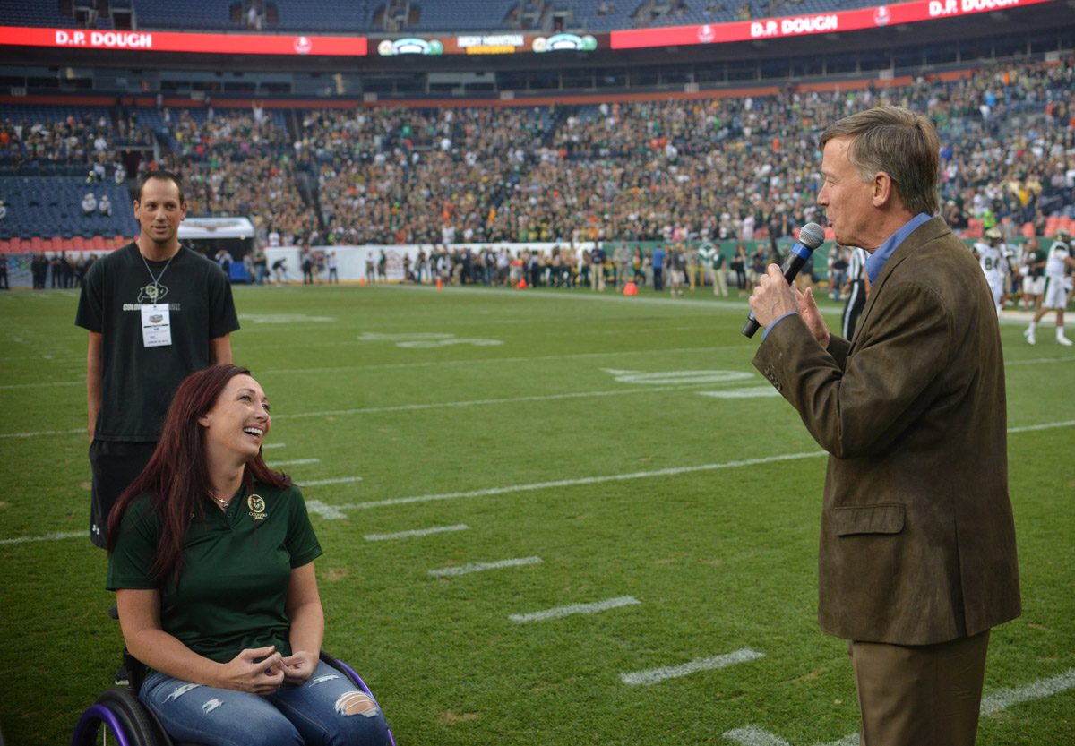 Amy Van Dyken-Rouen and John Hickenlooper at the Rocky Mountain Showdown at Sports Authority Field at Mile High on Aug. 29, 2014. (credit: Evan Semón/CBS4)
