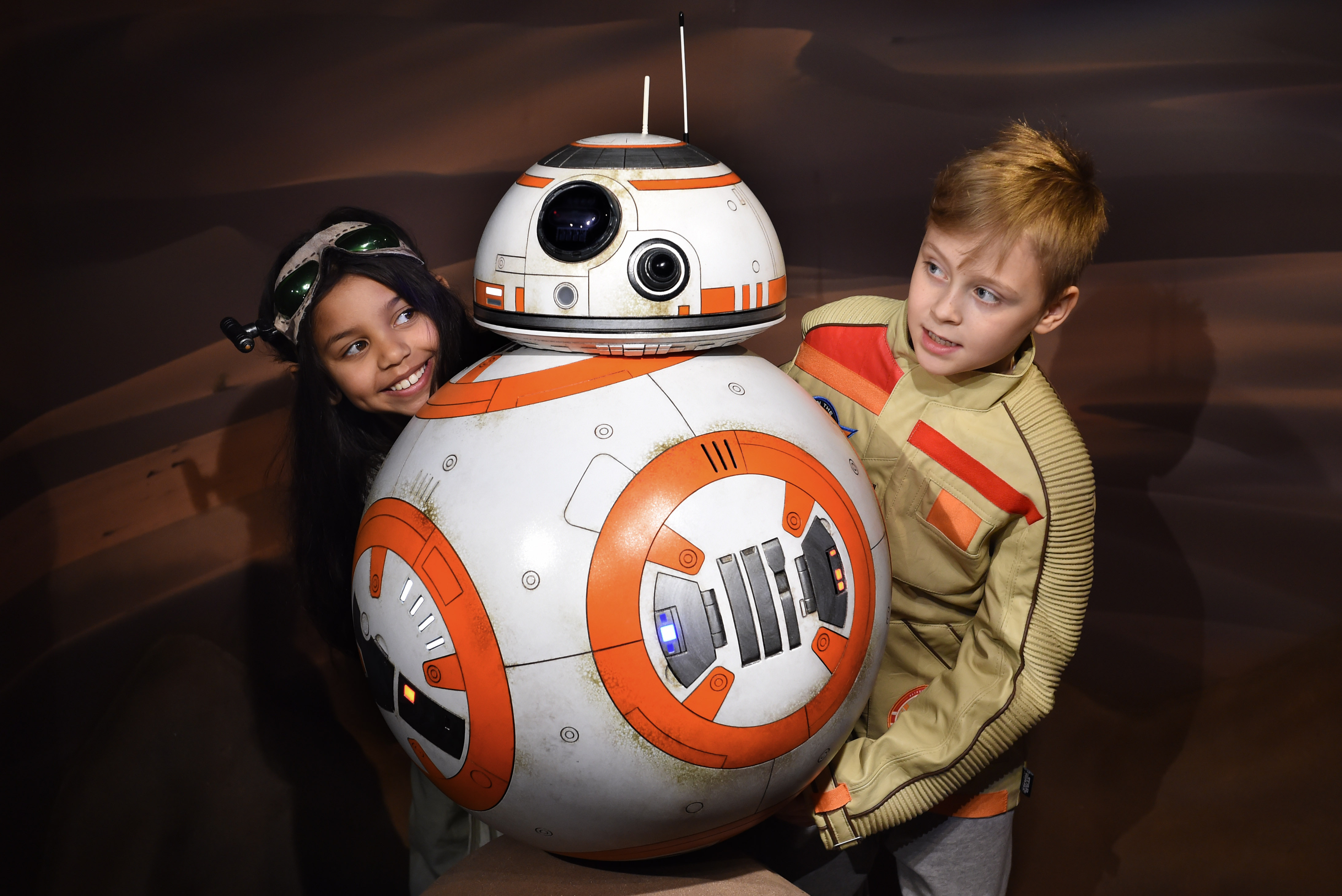 Star Wars fans pose with the new BB8 figure unveiled at Madame Tussauds London on March 21, 2016 in London. (credit: Stuart C. Wilson/Getty Images)