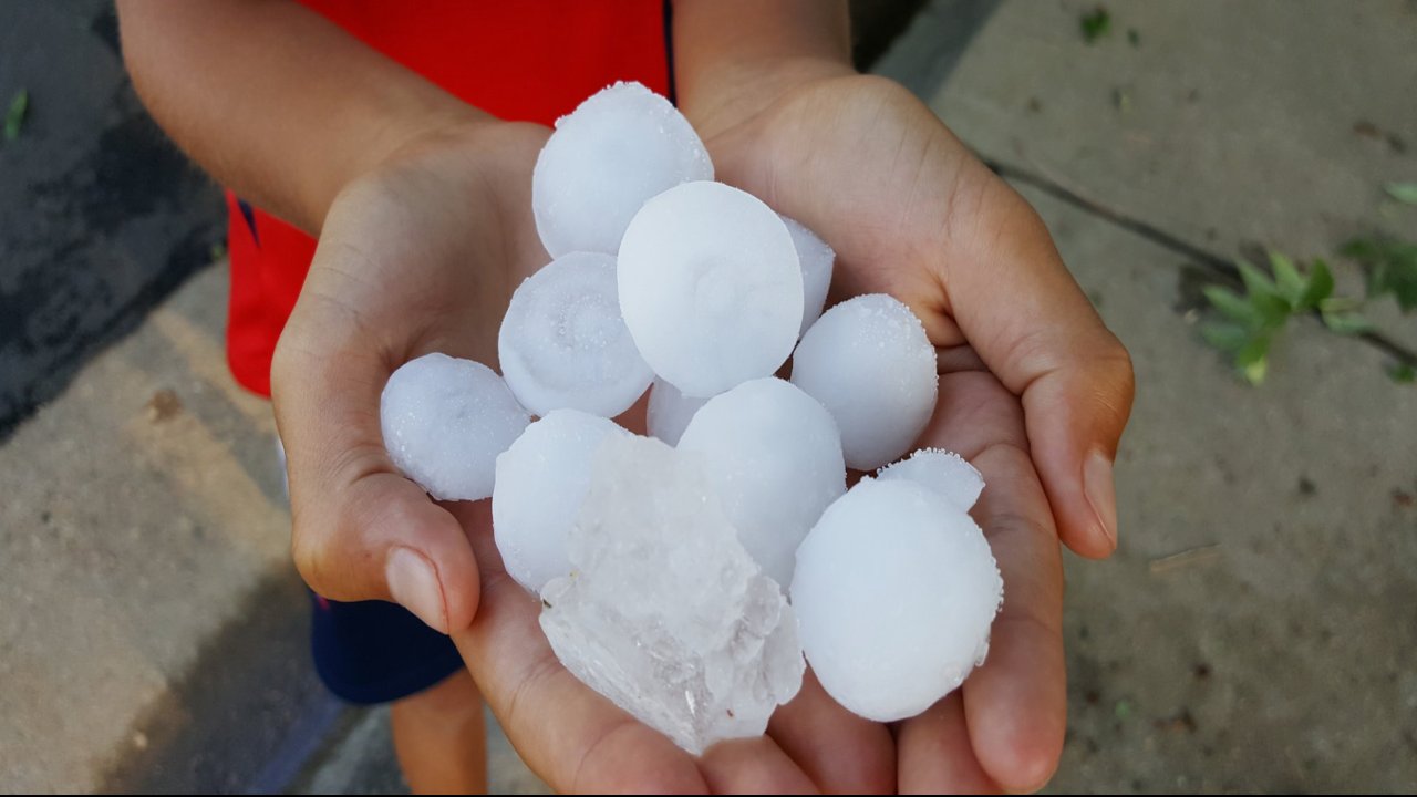 Tasso Leontaritis holds large hail that fell in Greenwood Village late Friday afternoon. (credit: Rob McClure)
