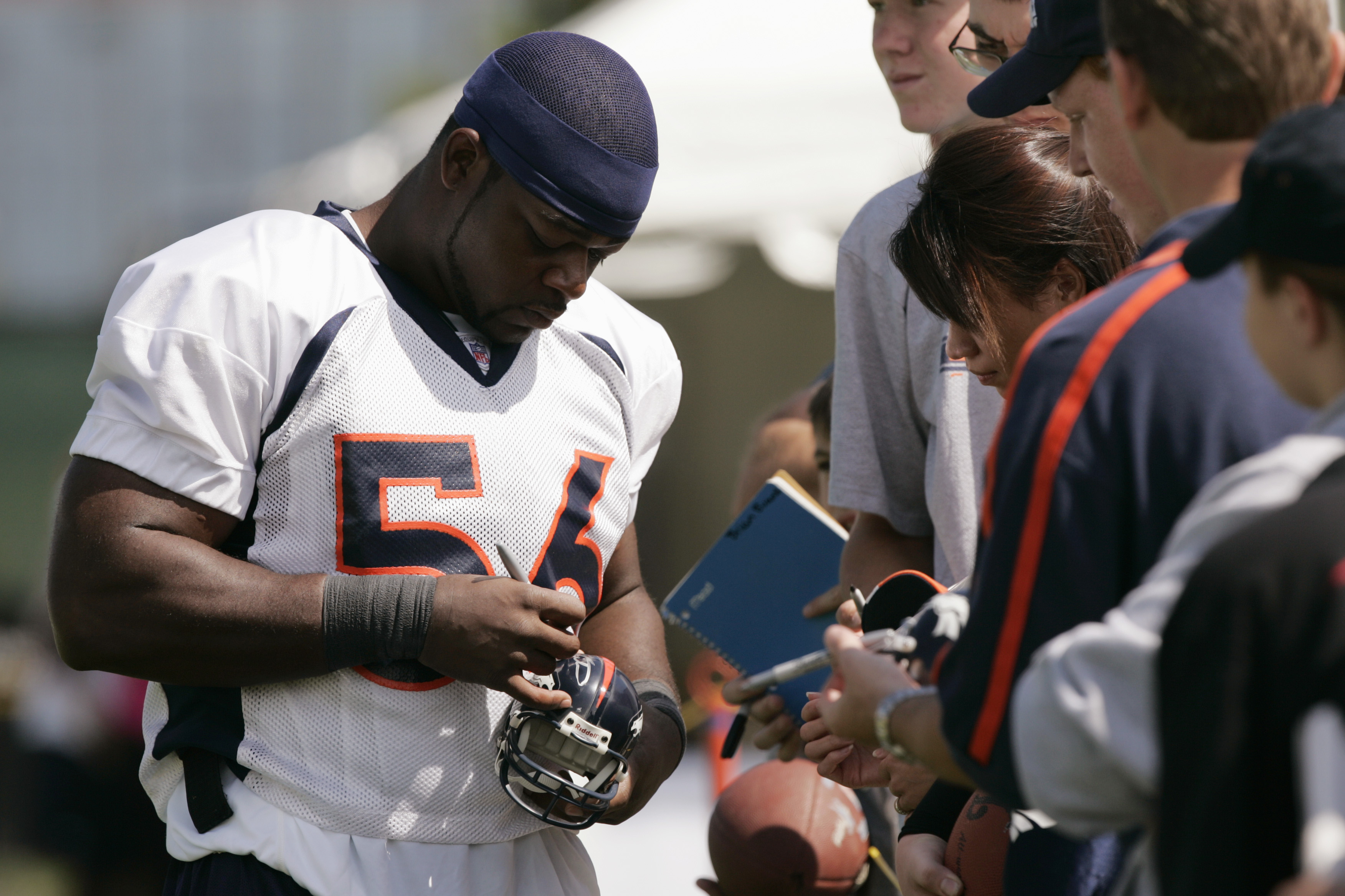 Linebacker Donnie Spragan of the Denver Broncos signs autographs for fans during training camp on July 28, 2004. (credit: Brian Bahr/Getty Images)