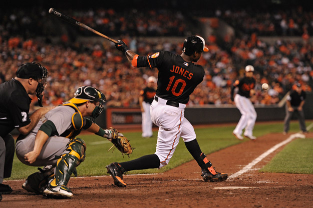 BALTIMORE, MD - AUGUST 23: Adam Jones #10 of the Baltimore Orioles hits an RBI against the Oakland Athletics in the seventh inning at Oriole Park at Camden Yards on August 23, 2013 in Baltimore, Maryland. The Baltimore Orioles won, 9-7.