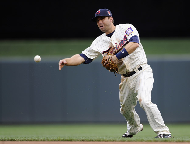 MINNEAPOLIS, MN - JUNE 7: Brian Dozier #2 of the Minnesota Twins throws to first base to get out Jose Altuve #27 of the Houston Astros during the fifth inning of the game on June 7, 2014 at Target Field in Minneapolis, Minnesota. The Twins defeated the Astros 8-0.