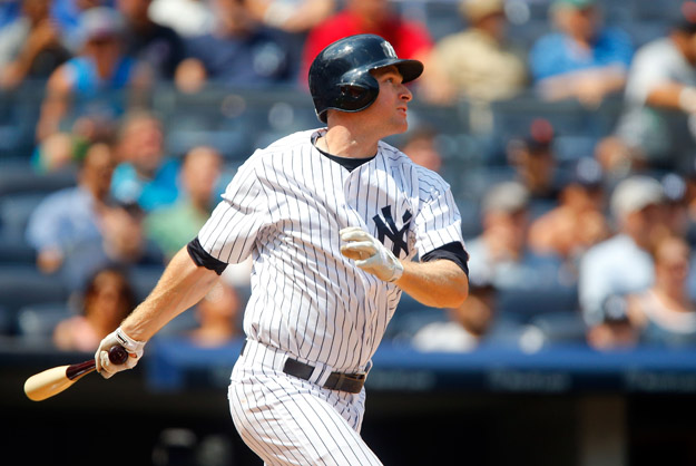 NEW YORK, NY - AUGUST 07:  Chase Headley #12 of the New York Yankees follows through on a fourth inning base hit against the Detroit Tigers at Yankee Stadium on August 7, 2014 in the Bronx borough of New York City.